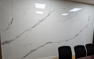 Meeting room with glossy white marble-type wall cladding